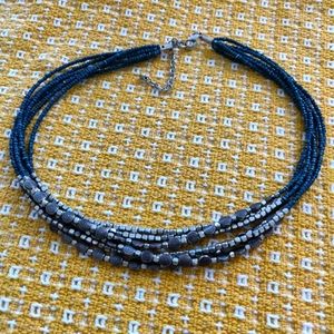 Multi-strand seed bead and silver beads.